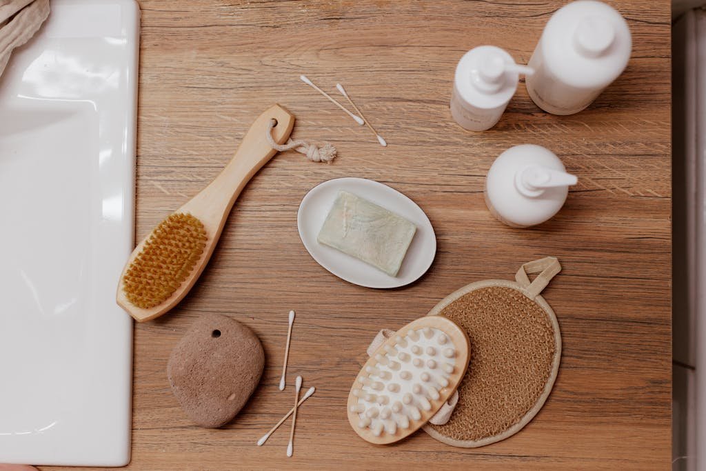 Top view of natural bath and spa accessories on a wooden surface, ideal for relaxation and skincare themes.