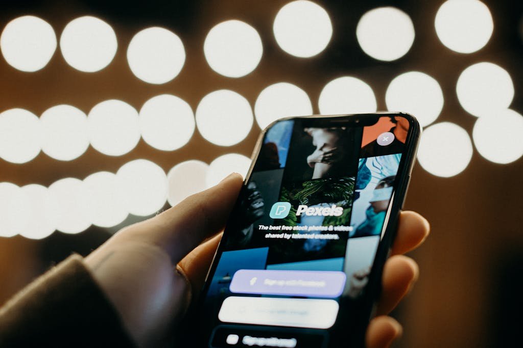 ClickUp Login of a smartphone displaying an app interface with a blurred bokeh background for a modern tech feel.