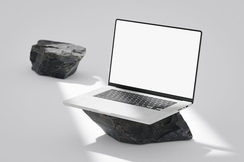 ClickUp's Product Launch Template with blank screen balanced on rocks in a minimalist setting.
