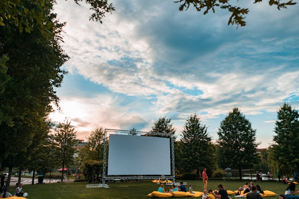Experience the S.S. Rajamouli's Movies cinema surrounded by lush greenery and a beautiful sunset.