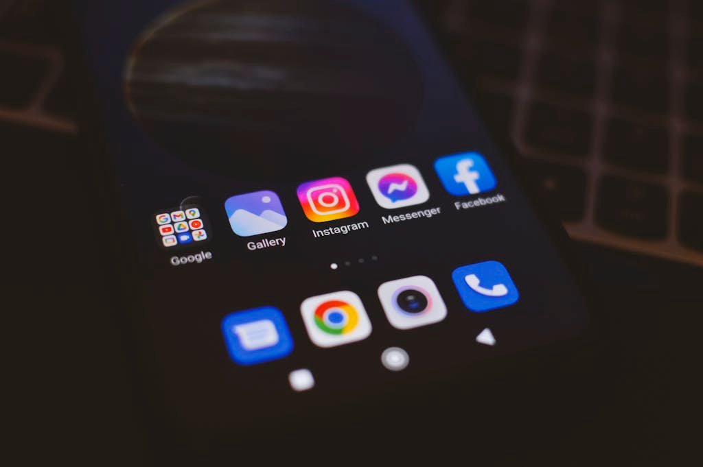 SnapSource in Software and Apps displaying popular social media apps in a dimly lit environment, perfect for tech and communication themes.