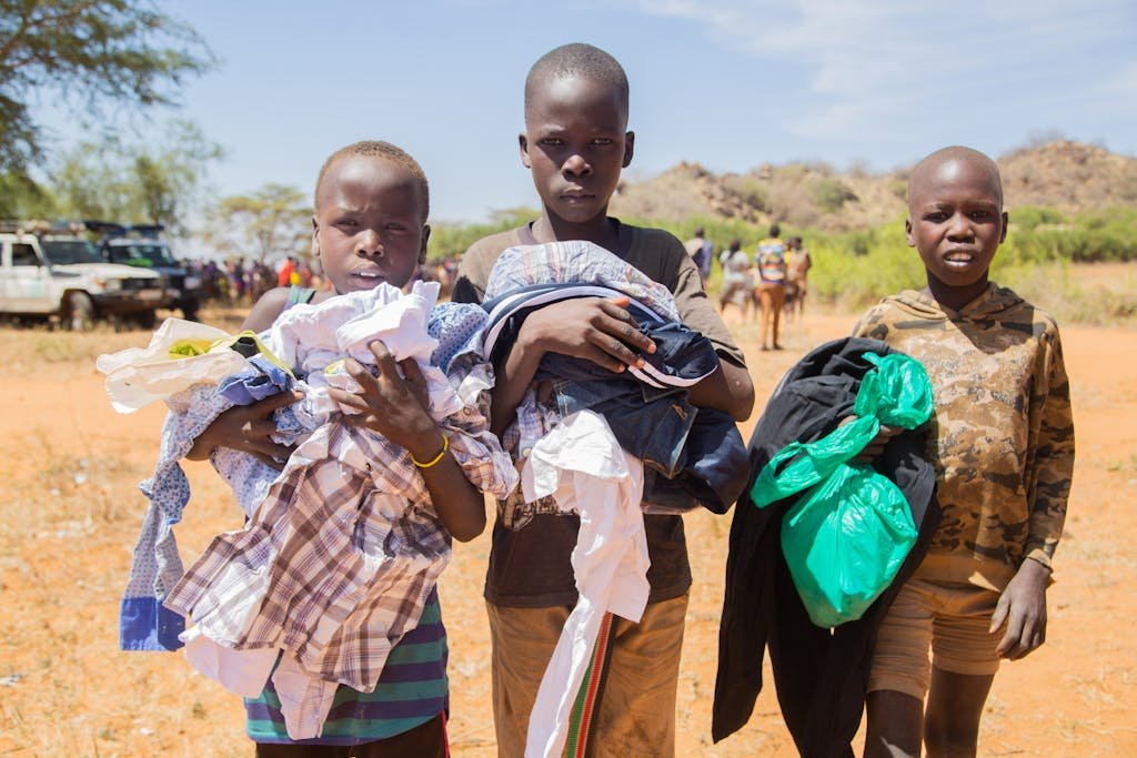 urakata de support shiteta carrying donated clothes in an outdoor rural setting on a sunny day.