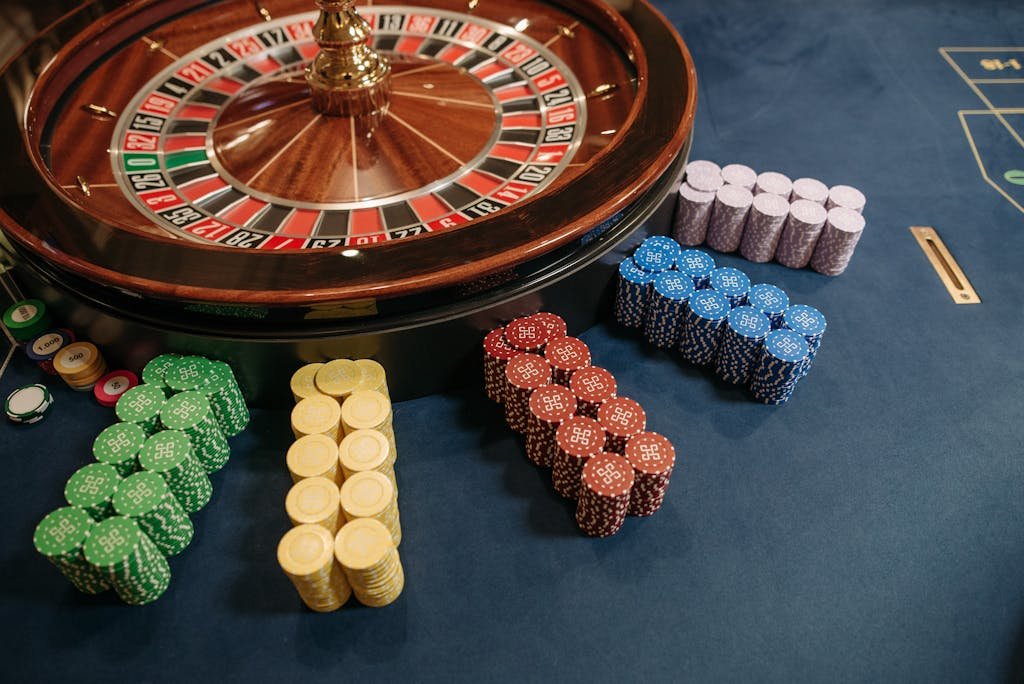 how to win in itmandoom17874 stacked beside a roulette wheel in a casino setting. 277bet.com