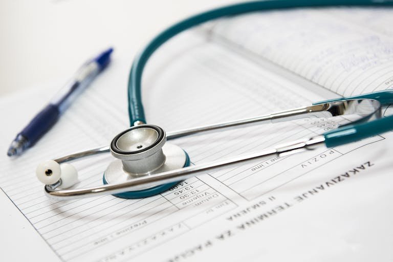 A WellHealthOrganic and pen resting on a medical report in a healthcare setting.