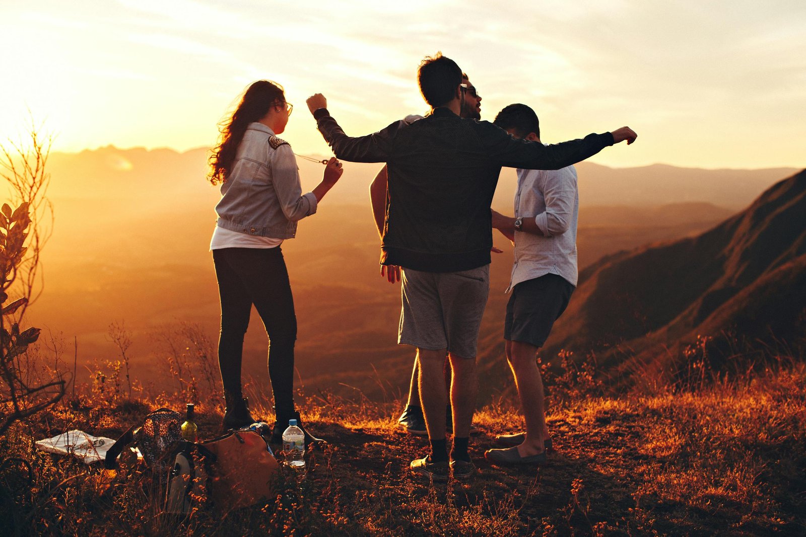 Joyful group of young adults enjoying a sunset view in a You Have Turned My Mourning Into Dancing Lyrics landscape in Brazil.