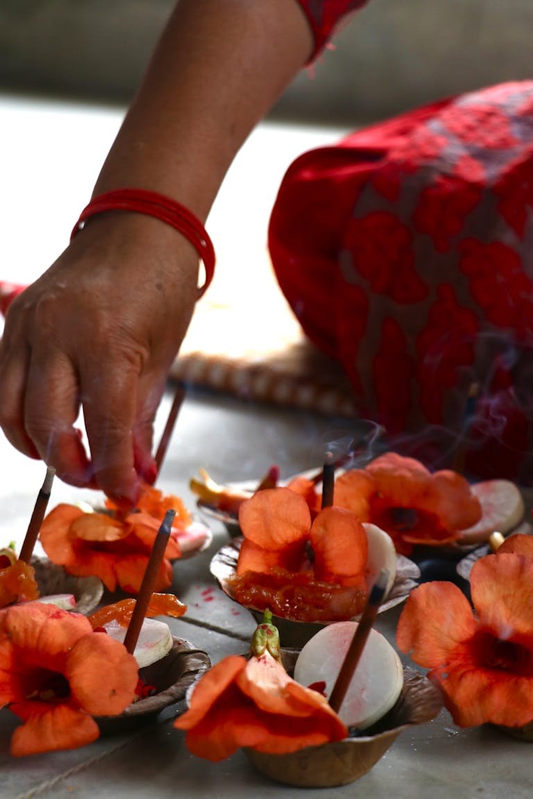 A shani levni ritual with flowers and incense showcasing spiritual devotion in Nepal.