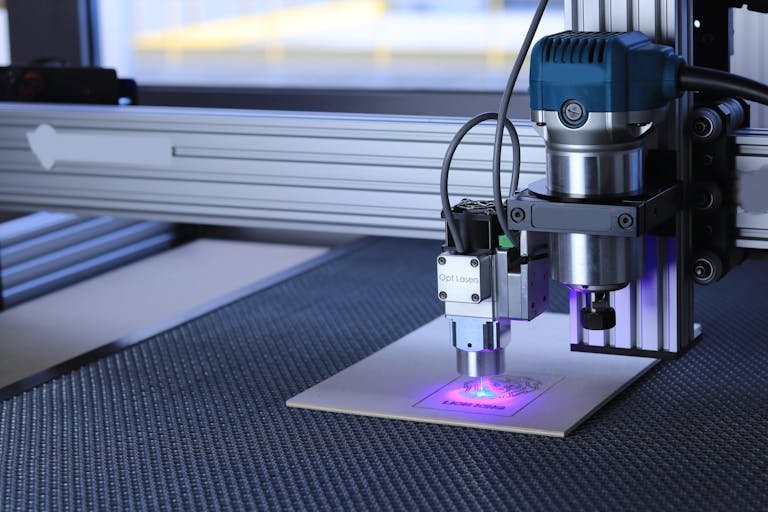 Close-up of a laser cutting Laser Engraving a design on metal using advanced technology.