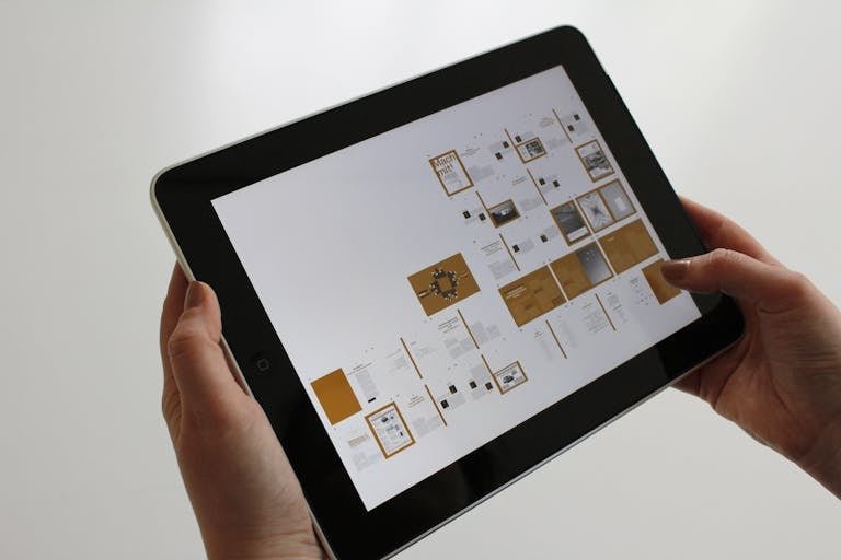 ClickUp Careers of hands using a tablet, displaying a digital interface.