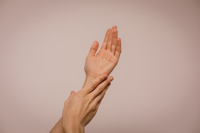 Skincare of hands gently caressing each other, symbolizing self-care and softness.