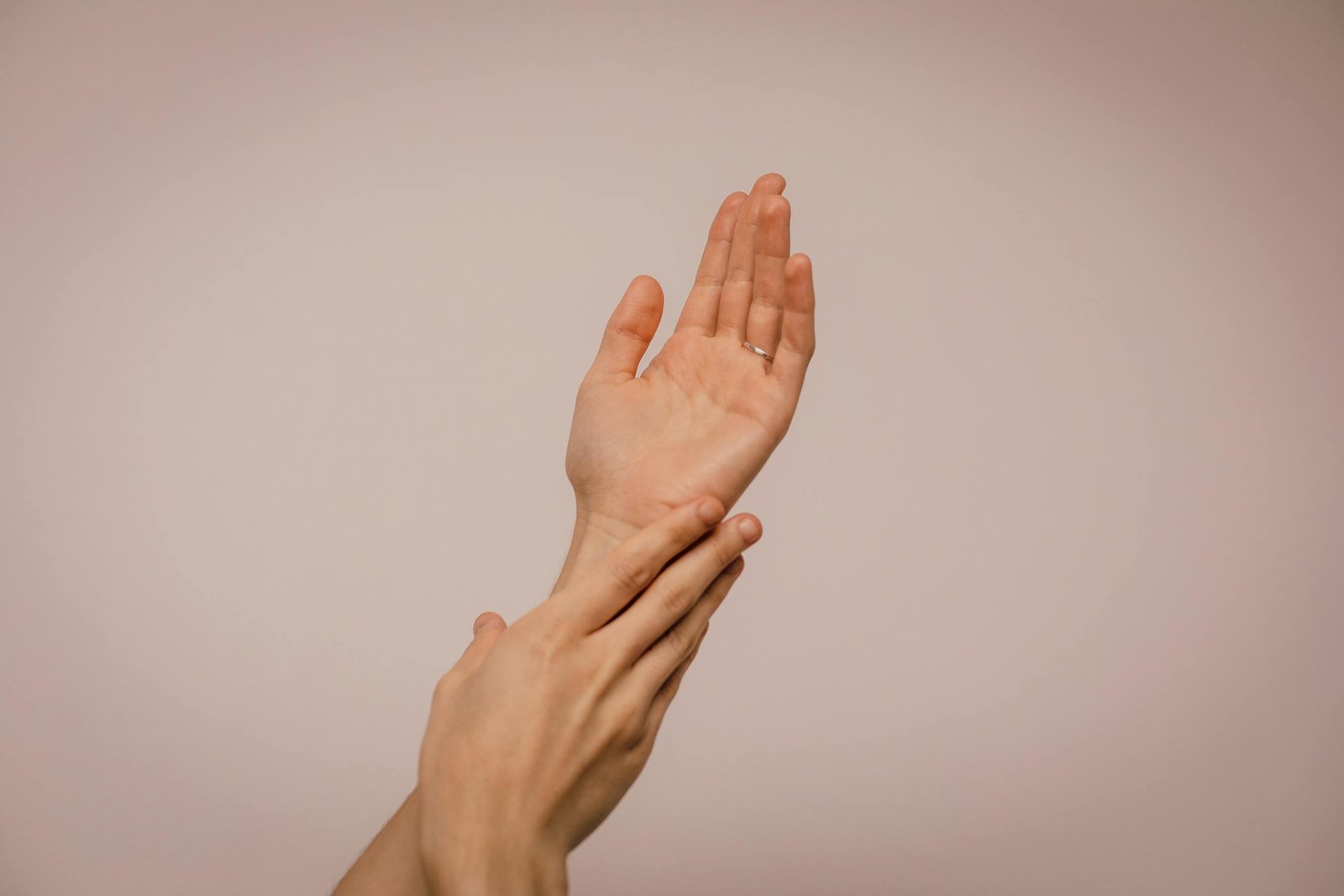 Skincare of hands gently caressing each other, symbolizing self-care and softness.
