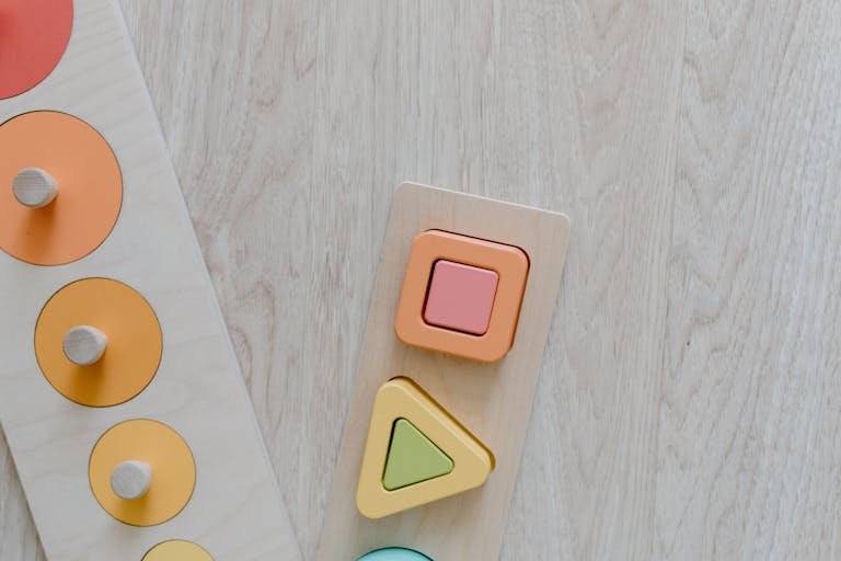 clicker up of a wooden kids toy puzzle with colorful geometric shapes for educational play.